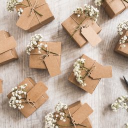 Square brown gifts with wedding flowers intwined
