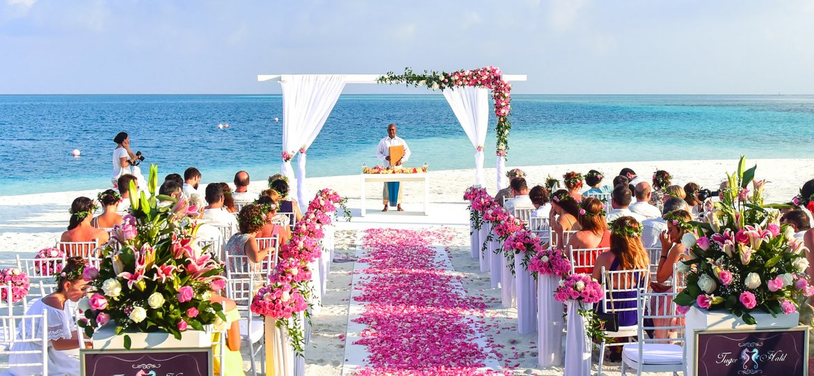 Wedding on beach with blue sea in background